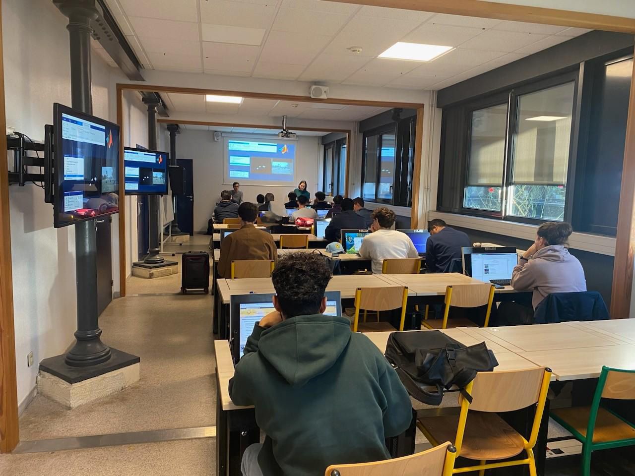 Students seated in a classroom learning to use MATLAB products.