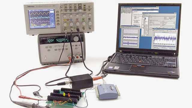 MATLAB being used to collect and visualize data from a test setup that includes a function generator, an oscilloscope, a circuit board, and connecting cables.